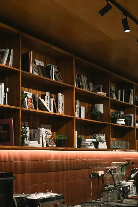 A warm office interior with wood bookshelves.