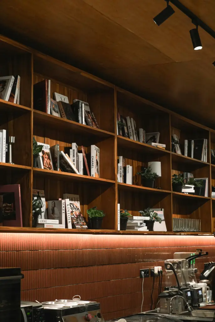 A warm office interior with wood bookshelves.